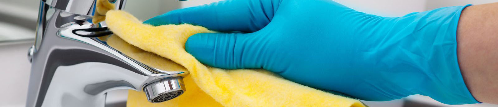 Close up blue gloved hand cleaning faucet with yellow rag for Cleaning with Krystal provides household cleaning services in south florida, Boca Raton, Palm Beach, North Broward, home cleaning services south florida